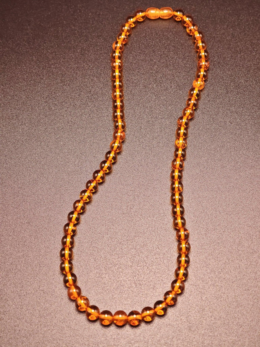 Bernstein-Kette mit glänzenden Perlen aus echtem Ostsee-Bernstein, handgefertigt und elegant präsentiert